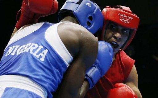 Ihab Almatbouli (R) of Jordan exchanges blows with Lukmon Lawal (L) of Nigeria